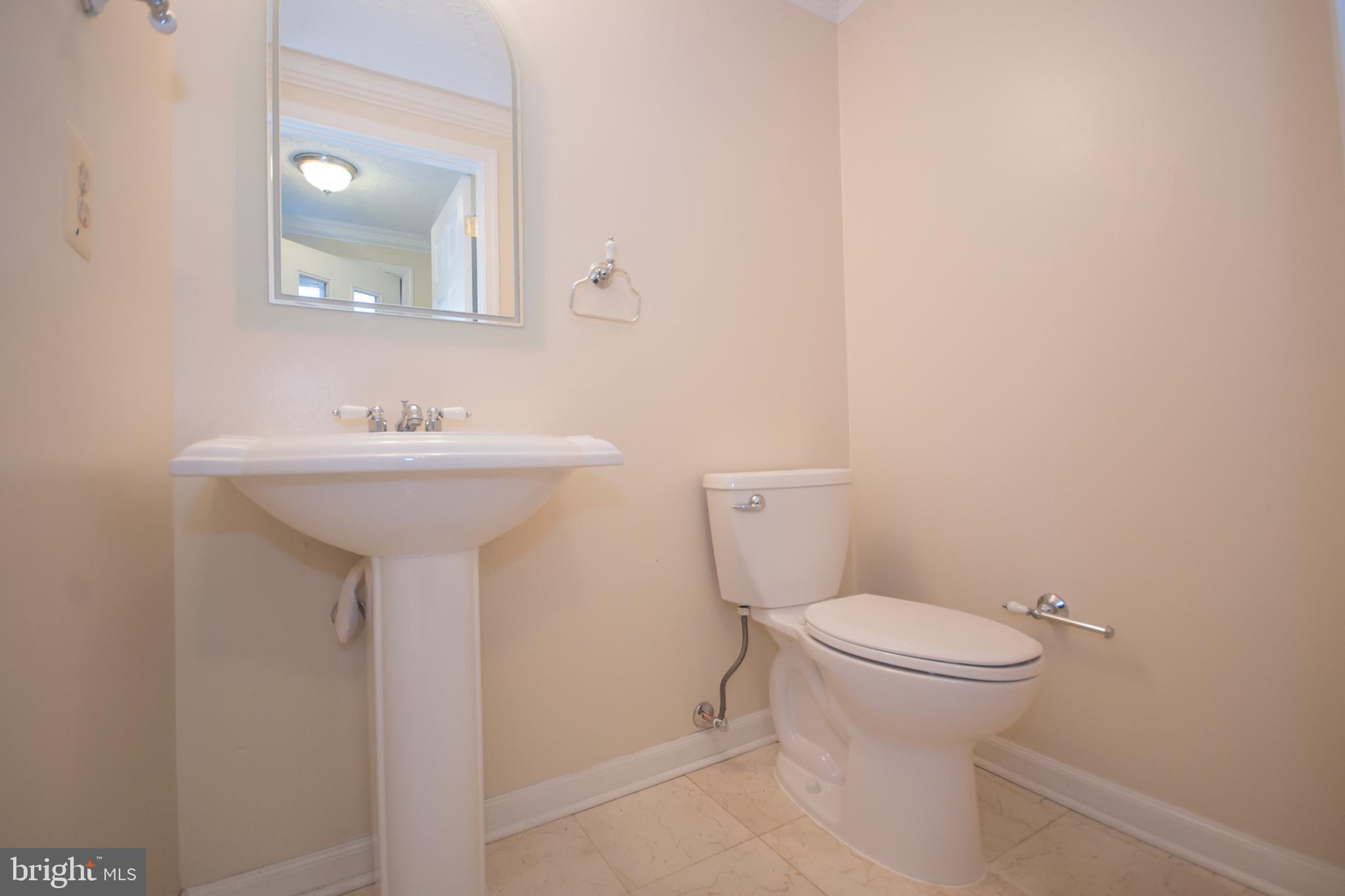7993 Tyson Oaks Circle Vienna, VA 22182 - Photo 23 of 25 a bathroom with a sink toilet and a mirror