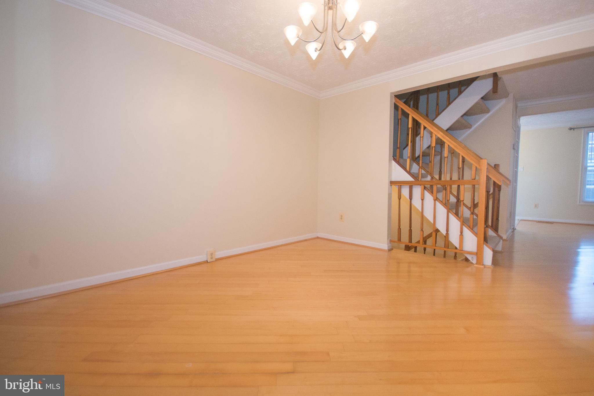 7993 Tyson Oaks Circle Vienna, VA 22182 - Photo 7 of 25 a view of an empty room with wooden floor and stairs