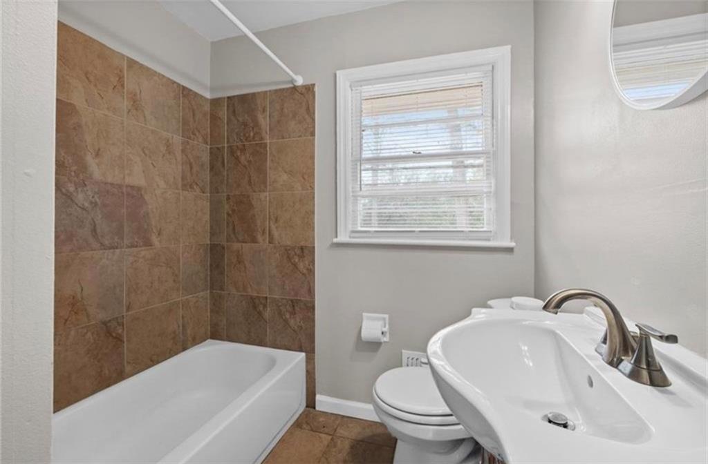 2911 Gresham Rd S East Atlanta, GA 30316 - Photo 15 of 22 a bathroom with a sink toilet and shower