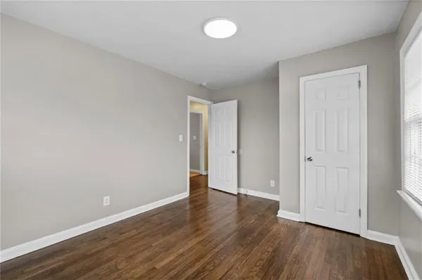 a view of an empty room with wooden floor