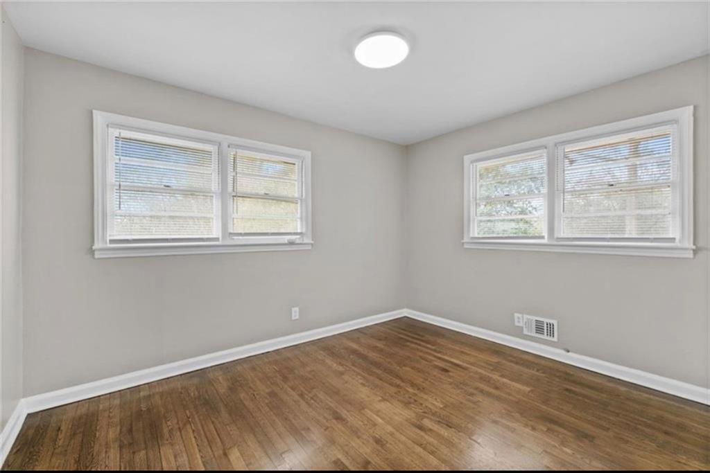 2911 Gresham Rd S East Atlanta, GA 30316 - Photo 18 of 22 a view of an empty room with wooden floor and a window