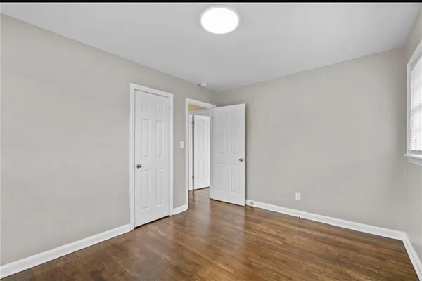 a view of an empty room and wooden floor