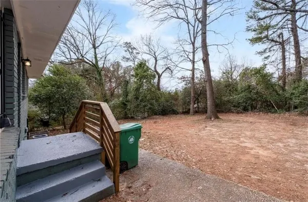 a view of a wooden deck and trees