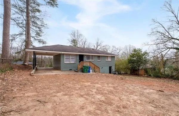 a view of a house with a yard and roof