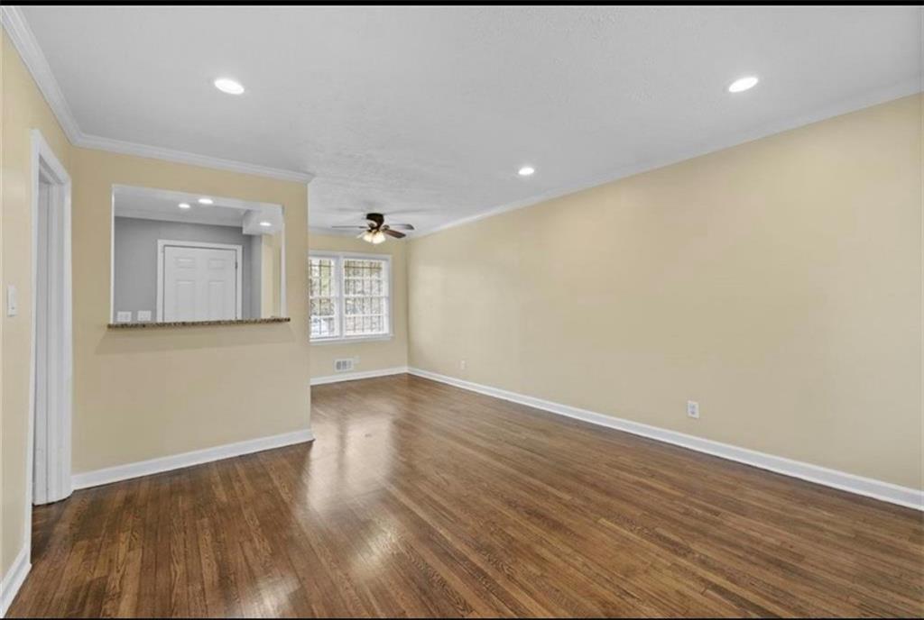 2911 Gresham Rd S East Atlanta, GA 30316 - Photo 5 of 22 wooden floor in an empty room with a window