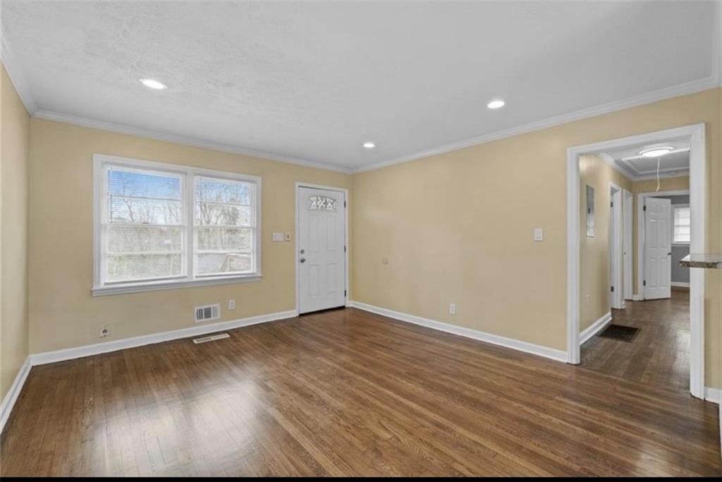 2911 Gresham Rd S East Atlanta, GA 30316 - Photo 7 of 22 an empty room with wooden floor and windows