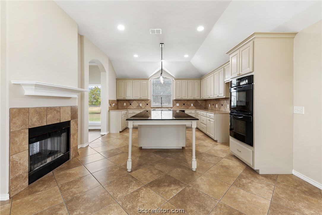 6100 Whitetail Lane Bryan, TX 77808 - Photo 11 of 37 a kitchen with refrigerator a microwave and stove