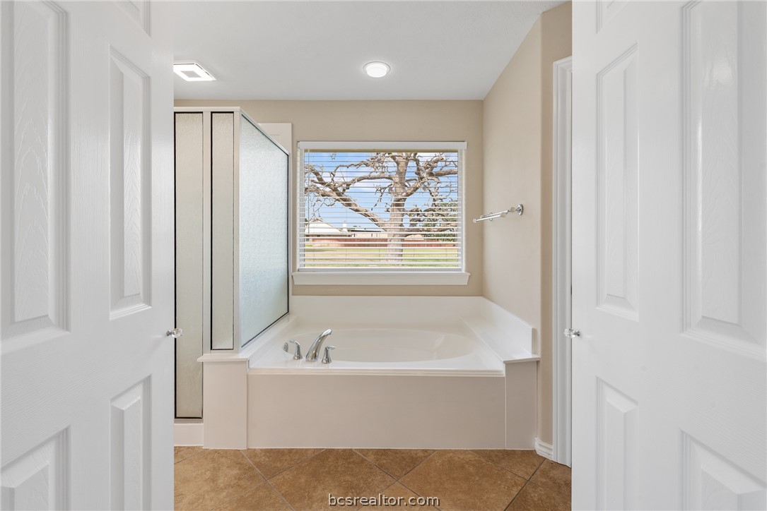 6100 Whitetail Lane Bryan, TX 77808 - Photo 18 of 37 a bathroom with a bathtub and shower