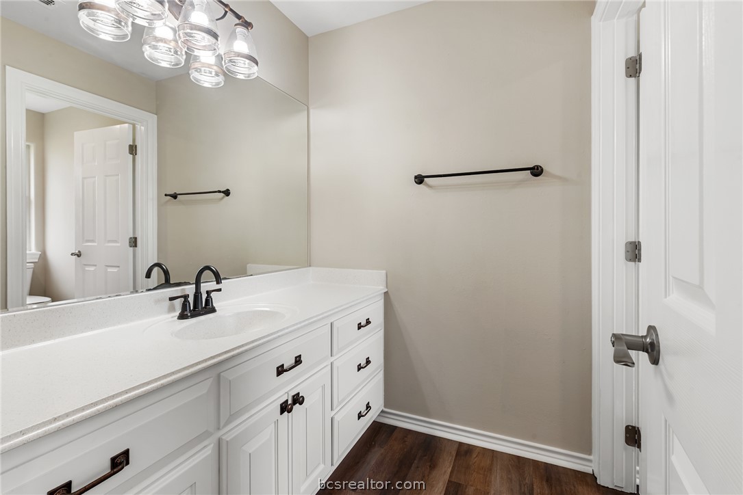 6100 Whitetail Lane Bryan, TX 77808 - Photo 23 of 37 a bathroom with a sink a light fixture and a mirror