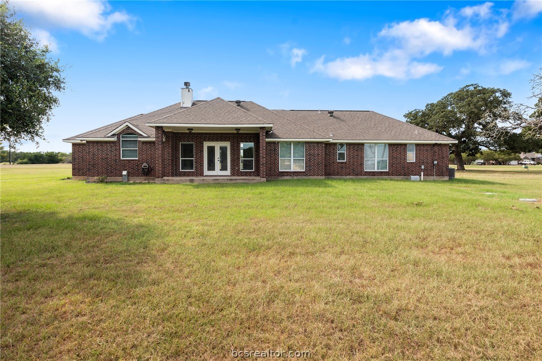 6100 Whitetail Lane Bryan, TX 77808 - Photo 28 of 37 a large house with a big yard and large trees