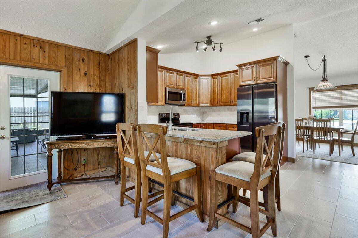 19681 Southeast County Line Road Tequesta, FL 33469 - Photo 13 of 45 a living room with furniture and a flat screen tv