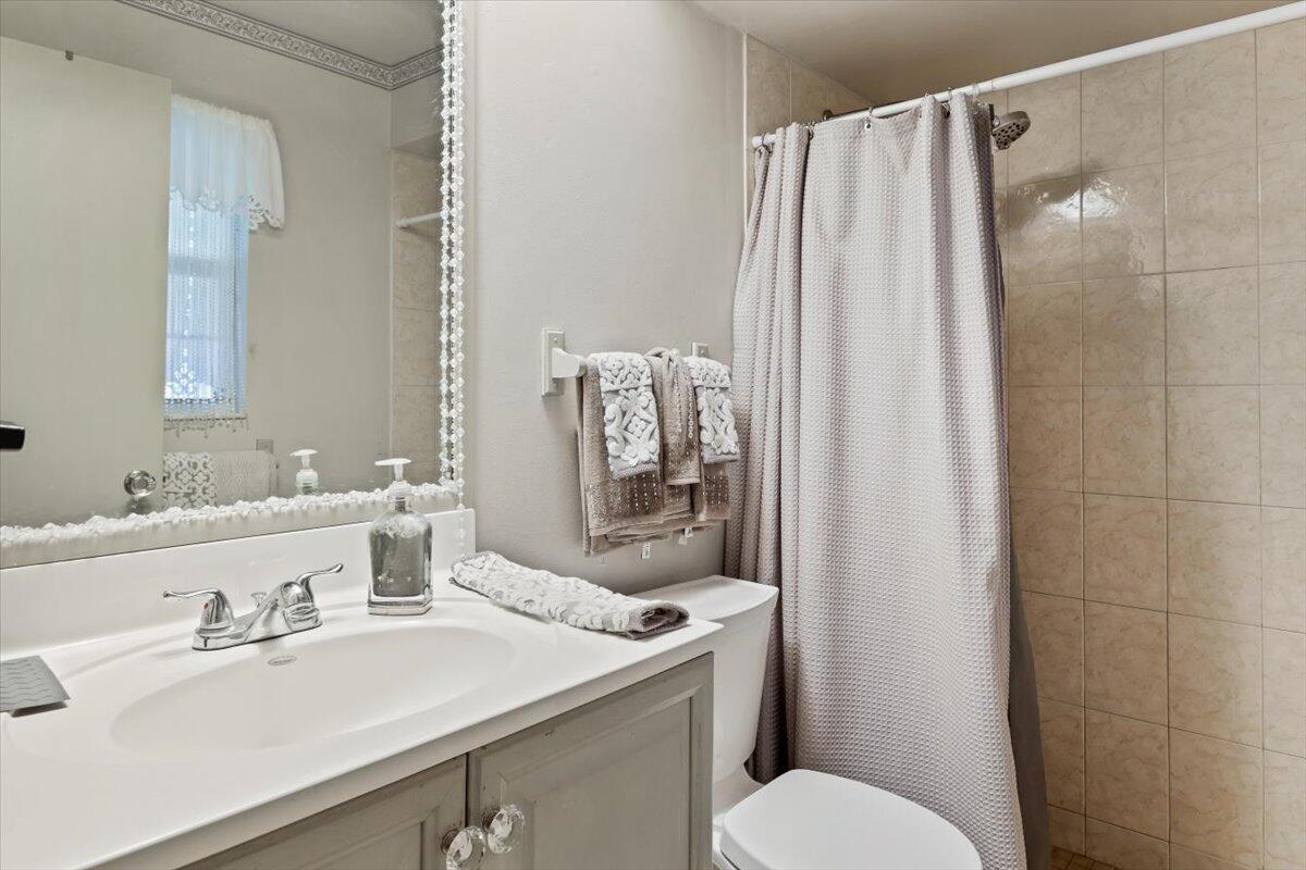19681 Southeast County Line Road Tequesta, FL 33469 - Photo 16 of 45 a bathroom with a sink toilet and shower