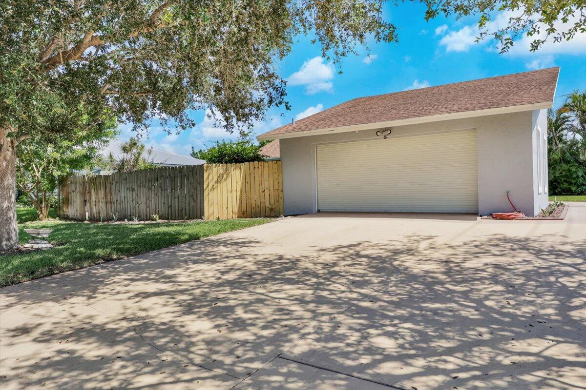 19681 Southeast County Line Road Tequesta, FL 33469 - Photo 3 of 45 a front view of a house with a yard