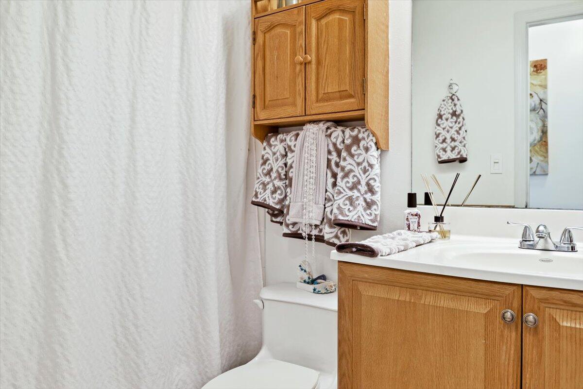 19681 Southeast County Line Road Tequesta, FL 33469 - Photo 22 of 45 a bathroom with a granite countertop sink and a mirror