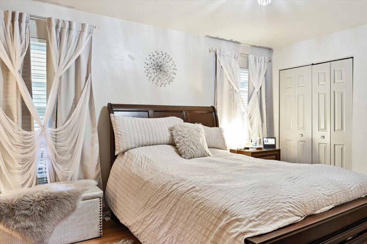 19681 Southeast County Line Road Tequesta, FL 33469 - Photo 23 of 45 a bedroom with a bed and a window