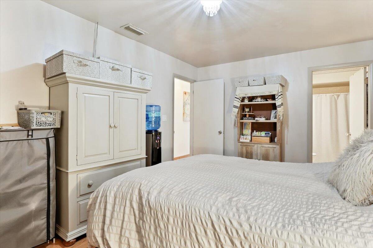 19681 Southeast County Line Road Tequesta, FL 33469 - Photo 24 of 45 a bedroom with a bed and a chandelier