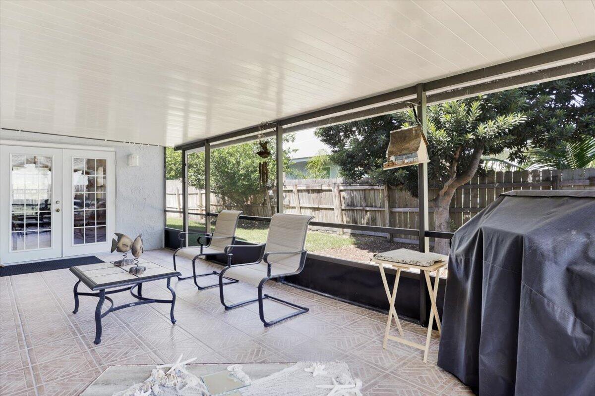 19681 Southeast County Line Road Tequesta, FL 33469 - Photo 27 of 45 a living room with furniture and a floor to ceiling window