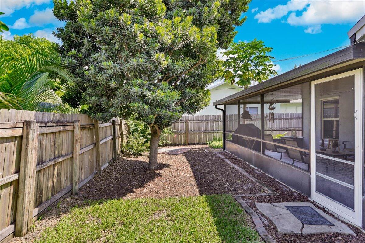19681 Southeast County Line Road Tequesta, FL 33469 - Photo 30 of 45 a view of a backyard with wooden fence and large trees
