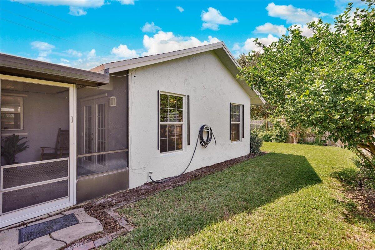 19681 Southeast County Line Road Tequesta, FL 33469 - Photo 32 of 45 a front view of a house with garden