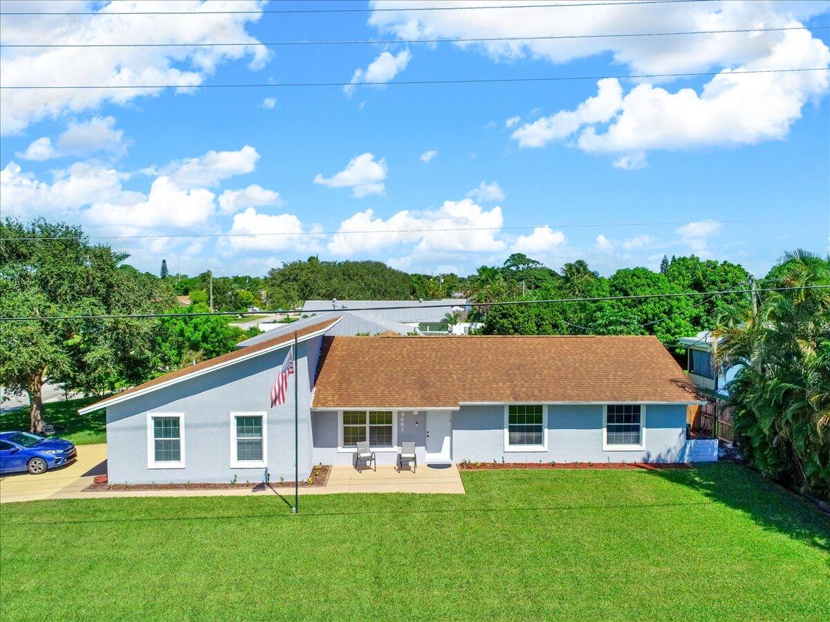 19681 Southeast County Line Road Tequesta, FL 33469 - Photo 33 of 45 a front view of house with yard and green space