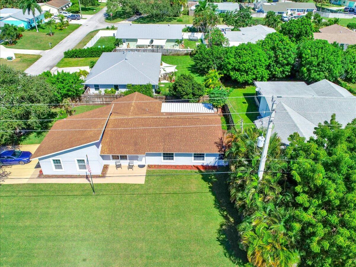 19681 Southeast County Line Road Tequesta, FL 33469 - Photo 34 of 45 an aerial view of a house with swimming pool garden and patio