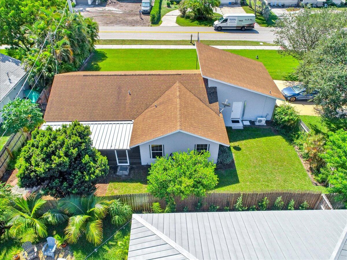19681 Southeast County Line Road Tequesta, FL 33469 - Photo 37 of 45 an aerial view of a house with a yard and a garden