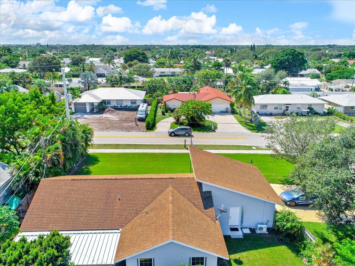 19681 Southeast County Line Road Tequesta, FL 33469 - Photo 38 of 45 a view of a building and a garden