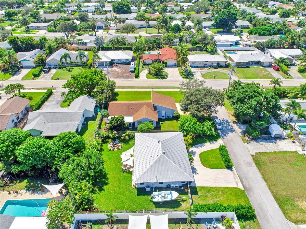 19681 Southeast County Line Road Tequesta, FL 33469 - Photo 39 of 45 an aerial view of residential houses with outdoor space and swimming pool