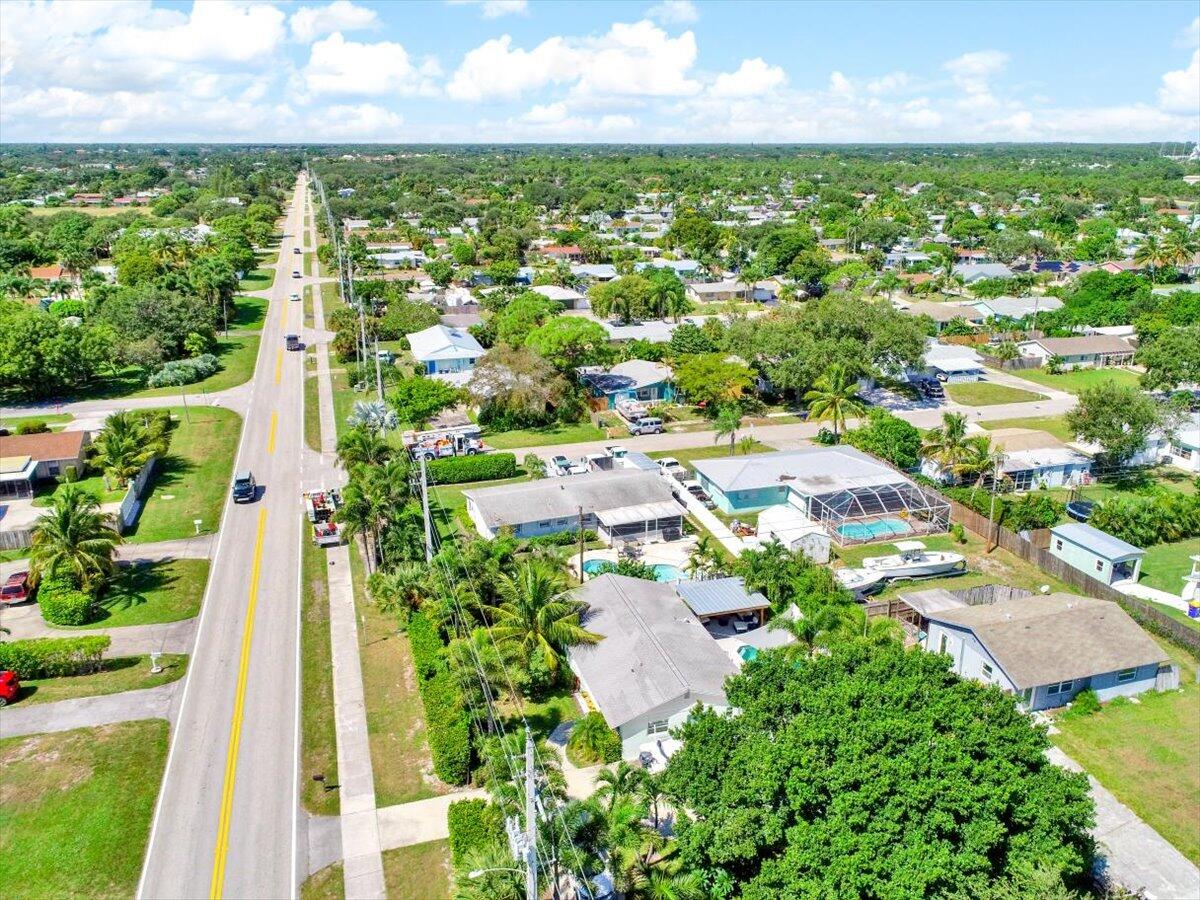 19681 Southeast County Line Road Tequesta, FL 33469 - Photo 40 of 45 an aerial view of residential houses with outdoor space and trees
