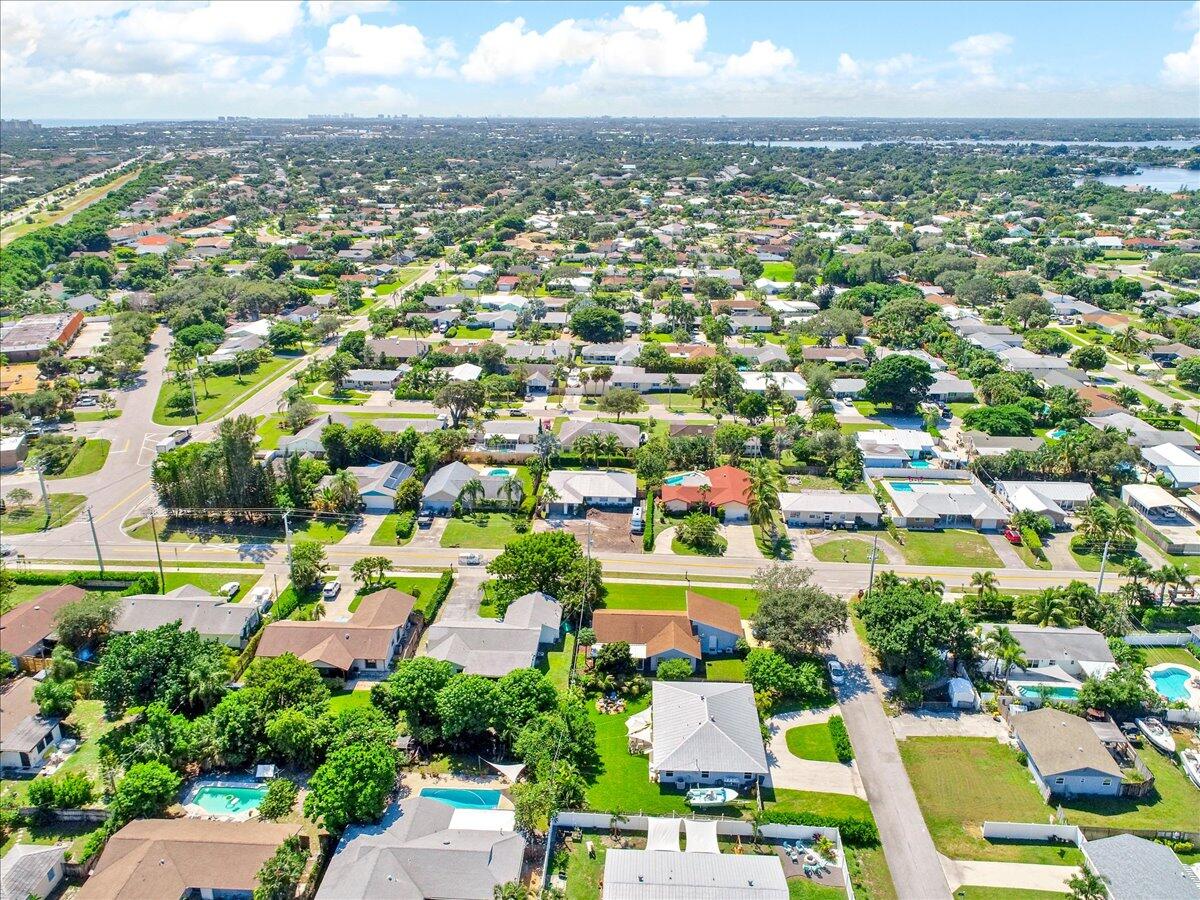 19681 Southeast County Line Road Tequesta, FL 33469 - Photo 45 of 45 an aerial view of residential houses with outdoor space and swimming pool