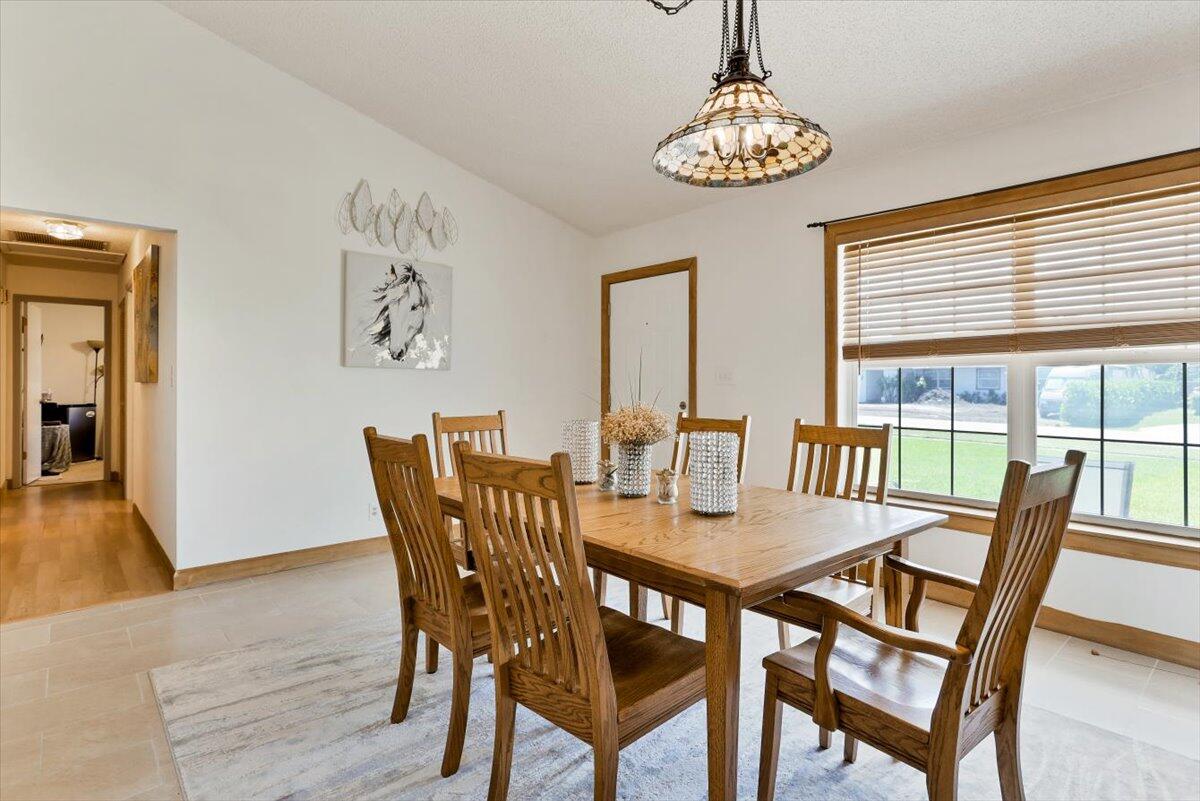 19681 Southeast County Line Road Tequesta, FL 33469 - Photo 7 of 45 a view of a dining room with furniture wooden floor and a chandelier