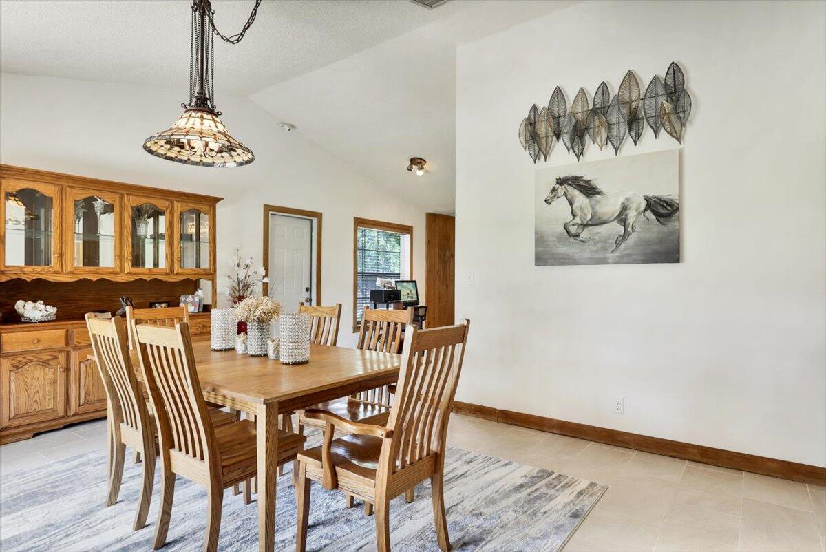 19681 Southeast County Line Road Tequesta, FL 33469 - Photo 8 of 45 a view of a dining room with furniture and wooden floor
