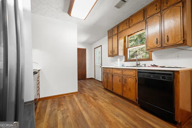 a kitchen with stainless steel appliances granite countertop a stove a sink and a refrigerator