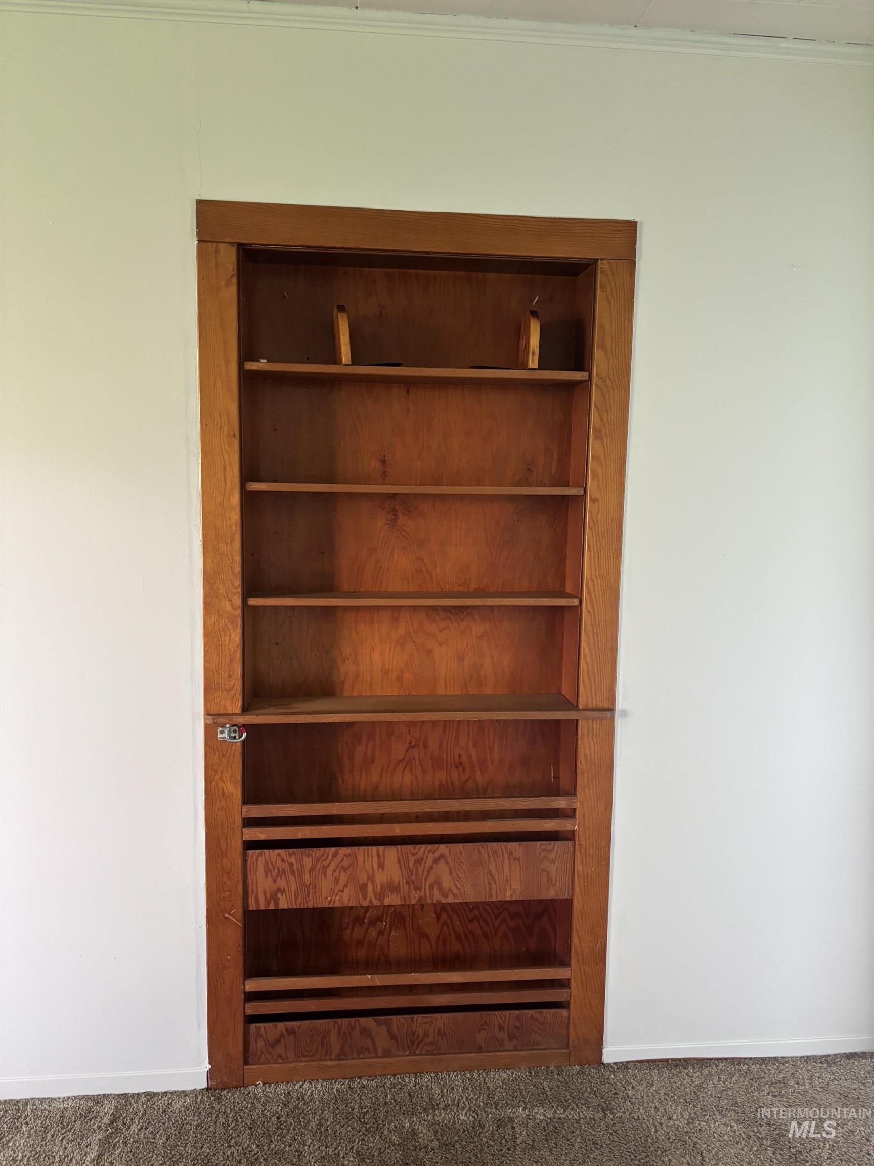 845 Malone Hill Road Pomeroy, WA 99347 - Photo 19 of 30 Built-in wood-finish shelving unit featuring multiple storage shelves and lower compartments