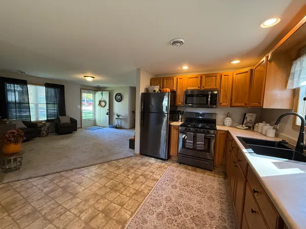 a kitchen with stainless steel appliances granite countertop a refrigerator and a sink