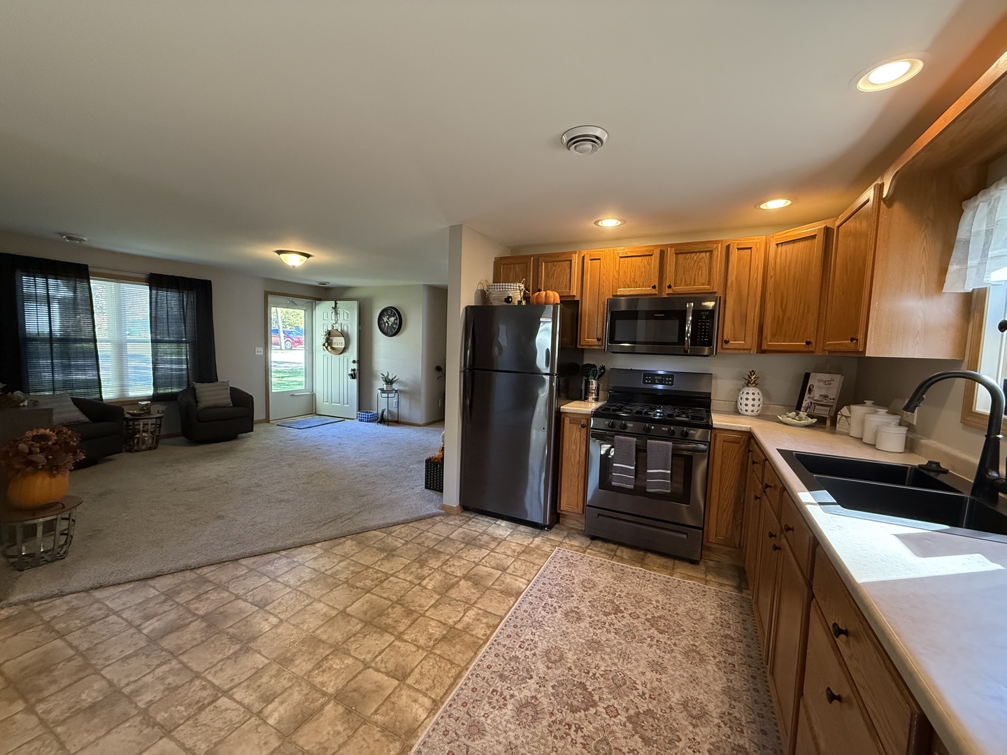 126 East Kerr Street Sycamore, IL 60178 - Photo 8 of 20 a kitchen with stainless steel appliances granite countertop a refrigerator and a sink