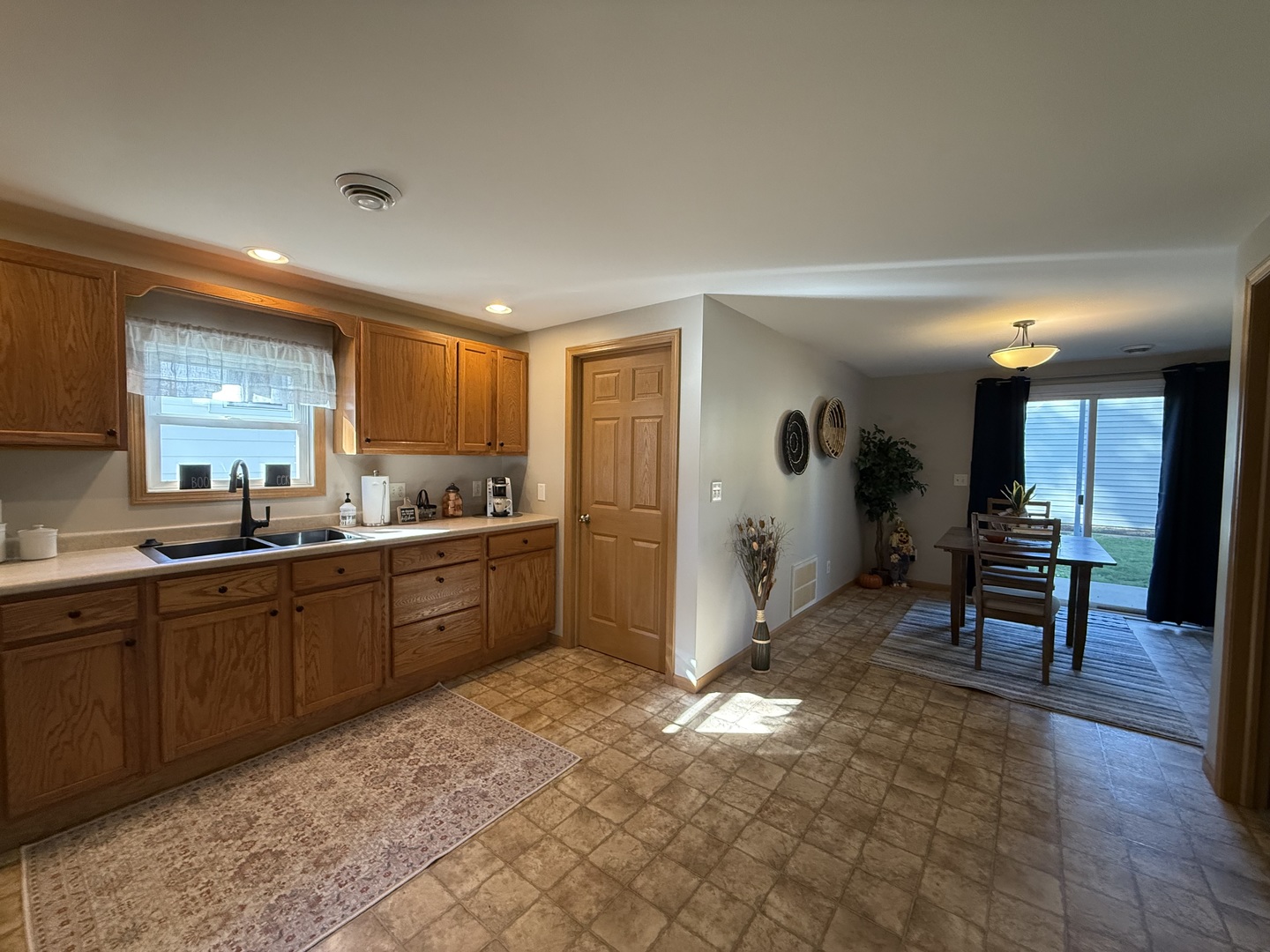 126 East Kerr Street Sycamore, IL 60178 - Photo 10 of 20 a large kitchen with cabinets table and chairs