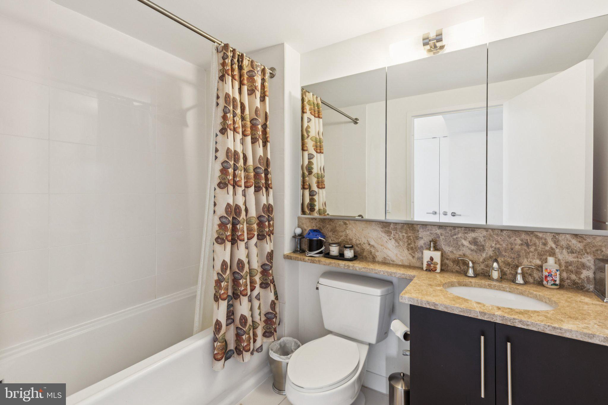 1425 Locust Street, Unit 21A Philadelphia, PA 19102 - Photo 6 of 8 a bathroom with a sink a toilet and shower