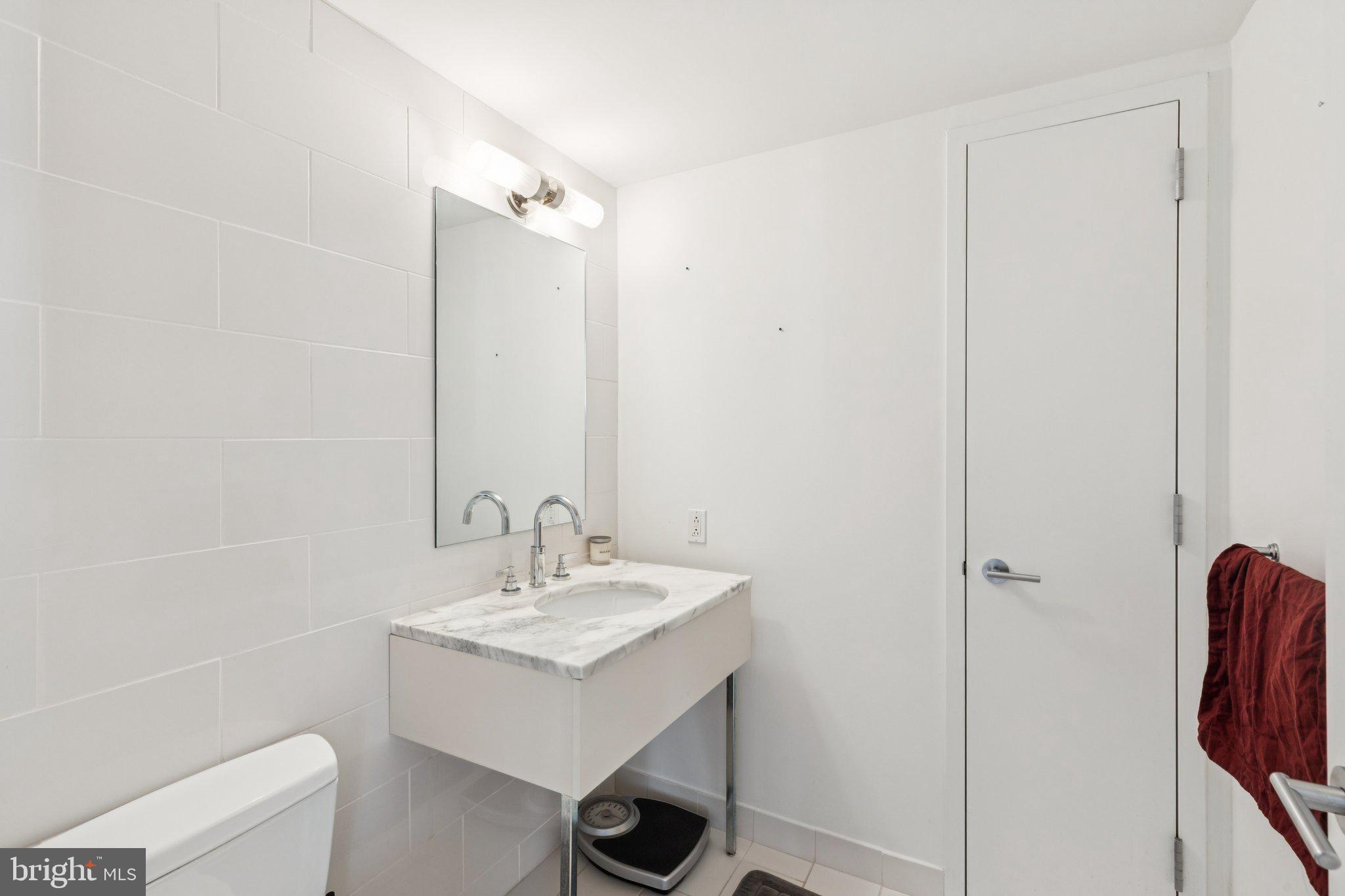 1425 Locust Street, Unit 21A Philadelphia, PA 19102 - Photo 7 of 8 a bathroom with a sink a toilet and shower
