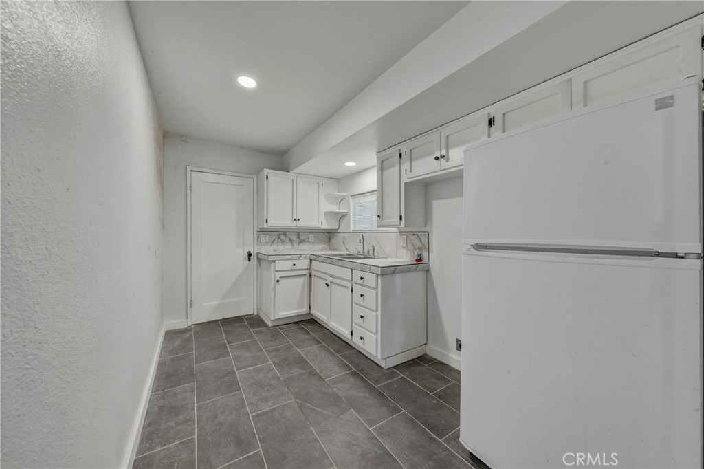 1980 Big Valley Road Lakeport, CA 95453 - Photo 21 of 56 a kitchen with white cabinets and white appliances