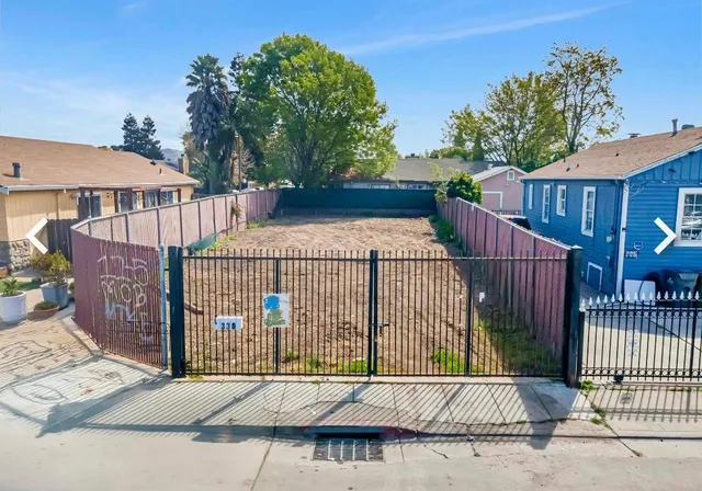 a view of a brick house with wooden floor in front of it
