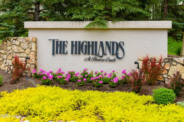 a view of front door of house and flowers