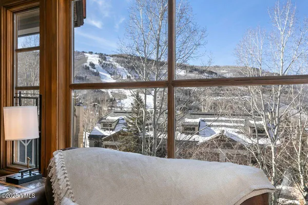 a living room filled with furniture and a floor to ceiling window