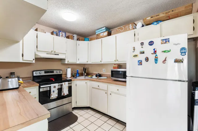 a white refrigerator freezer sitting in a kitchen