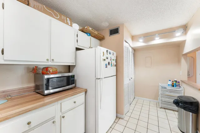 a kitchen with stainless steel appliances a refrigerator sink and cabinets