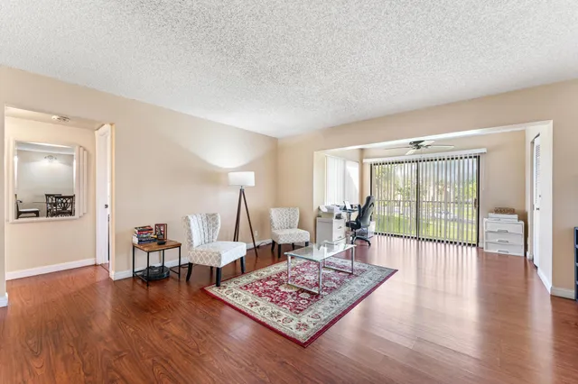 a living room with furniture and wooden floor