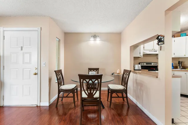 a view of a dining room with furniture and wooden floor