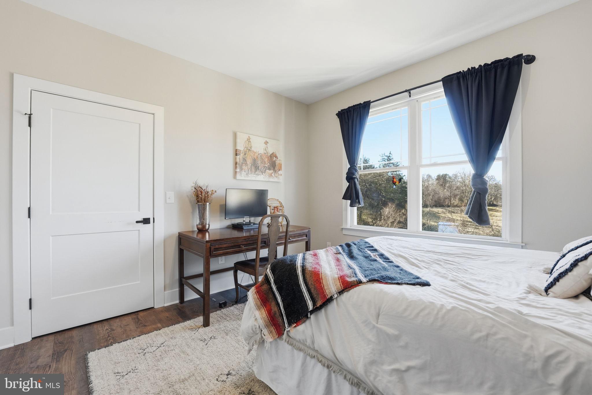 11183 Drogheda Mountain Road Culpeper, VA 22701 - Photo 19 of 60 a bedroom with a bed and large windows
