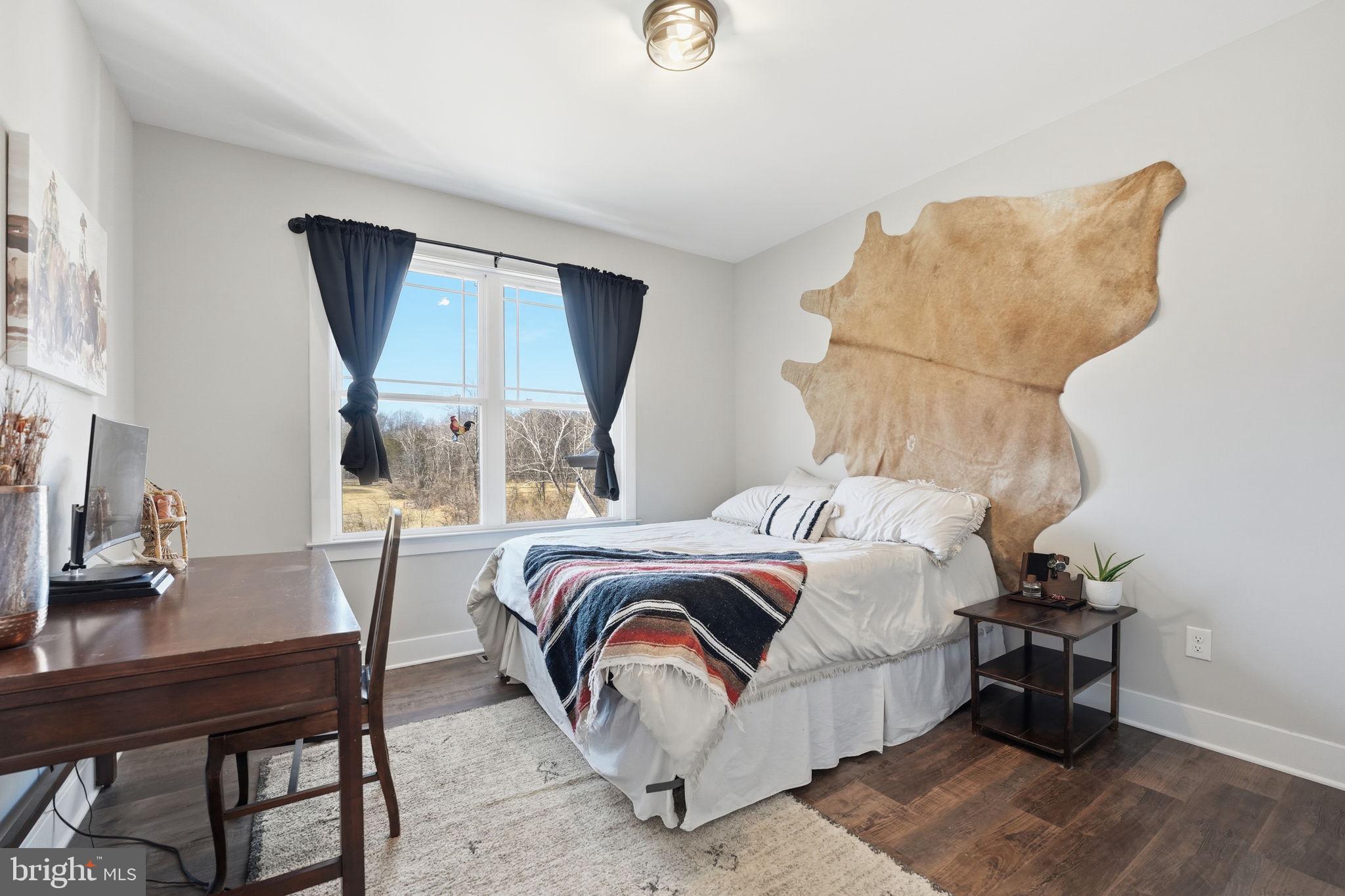 11183 Drogheda Mountain Road Culpeper, VA 22701 - Photo 20 of 60 a bedroom with a bed a table and chair