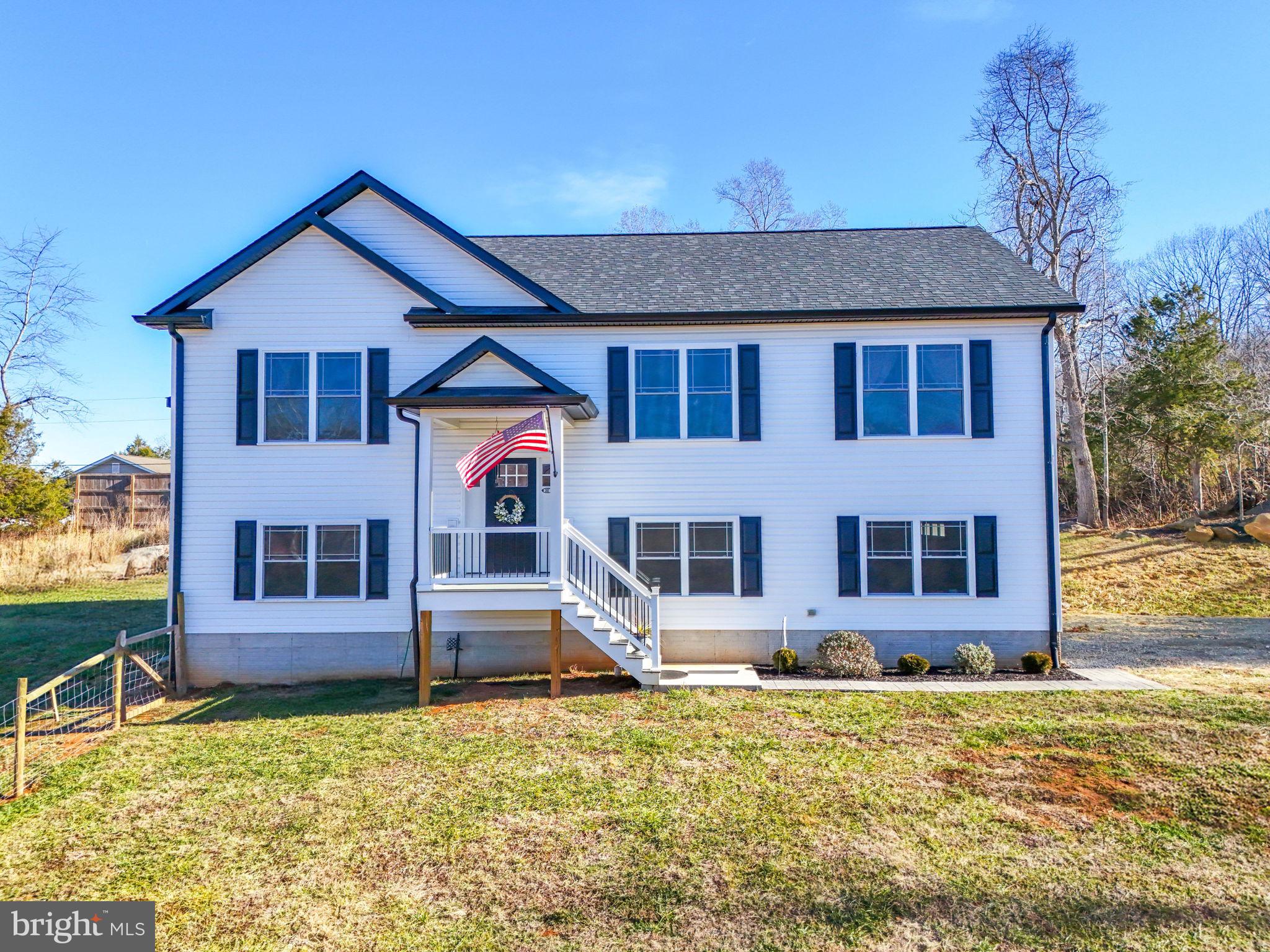 11183 Drogheda Mountain Road Culpeper, VA 22701 - Photo 2 of 60 a front view of a house with large windows